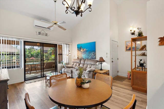 dining area featuring high vaulted ceiling, light hardwood / wood-style floors, a wall unit AC, and ceiling fan with notable chandelier