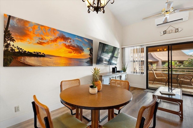 dining area with a wall mounted AC, ceiling fan with notable chandelier, and wood-type flooring