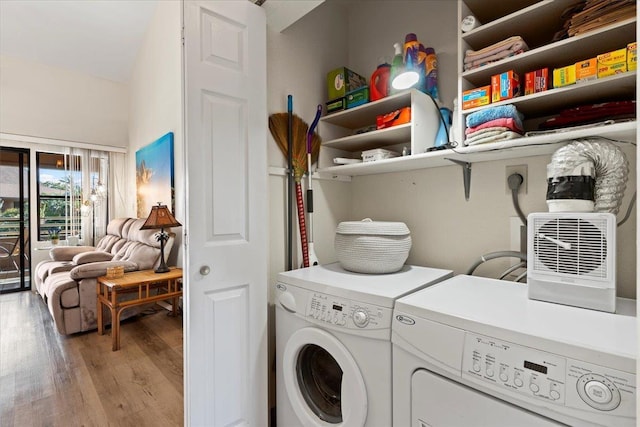 laundry room featuring independent washer and dryer and light hardwood / wood-style flooring