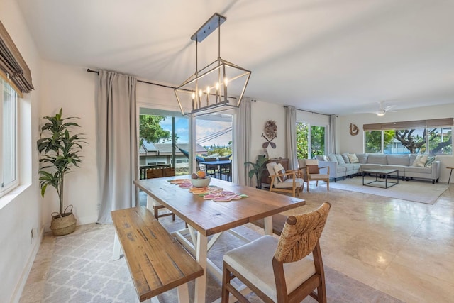 dining space featuring ceiling fan with notable chandelier and plenty of natural light