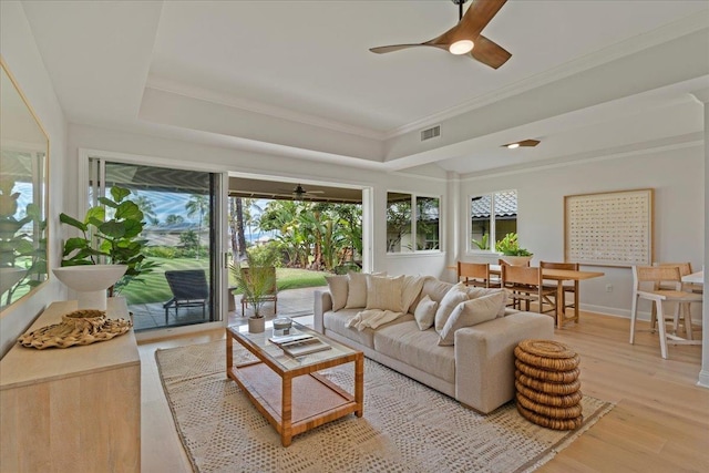 sunroom with a tray ceiling and ceiling fan