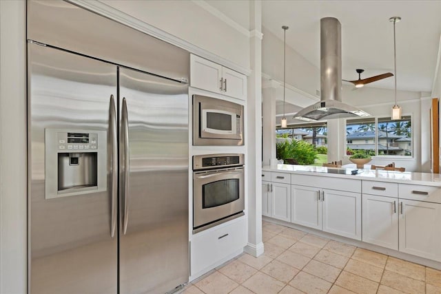 kitchen featuring built in appliances, white cabinetry, island exhaust hood, and pendant lighting