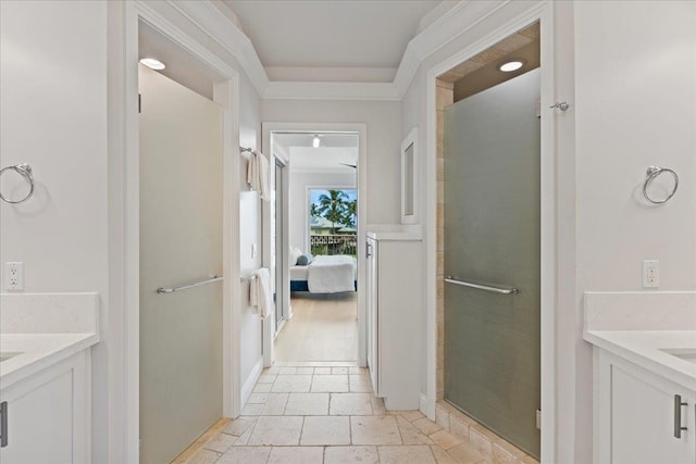 bathroom with vanity, ornamental molding, and an enclosed shower