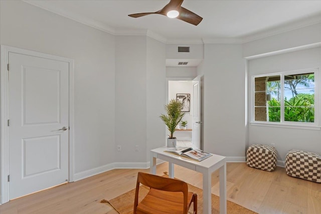 office featuring light hardwood / wood-style floors, ornamental molding, and ceiling fan