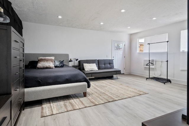bedroom with baseboards, light wood-style floors, recessed lighting, and a textured ceiling