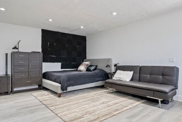 bedroom with recessed lighting and light wood-type flooring