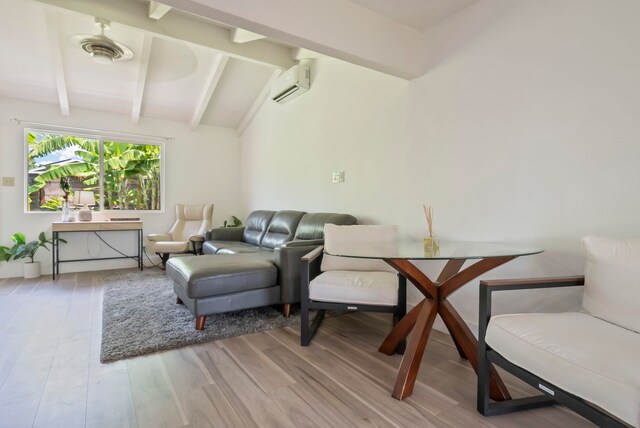 living room featuring a wall mounted air conditioner, wood finished floors, and lofted ceiling with beams