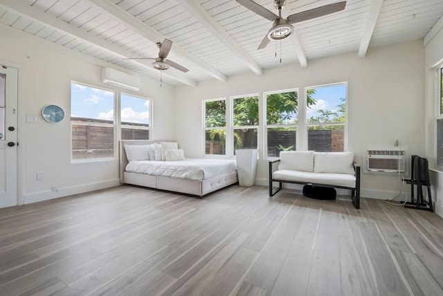 bedroom featuring a wall mounted AC, an AC wall unit, baseboards, beamed ceiling, and wood finished floors