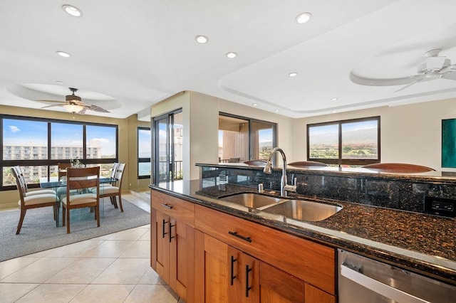 kitchen featuring a sink, ceiling fan, stainless steel dishwasher, and brown cabinets