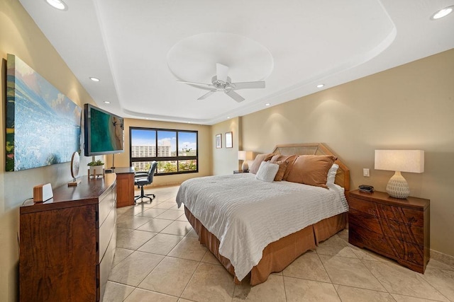 bedroom featuring baseboards, a tray ceiling, recessed lighting, and light tile patterned flooring