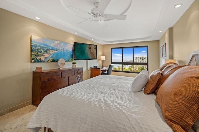 bedroom featuring baseboards, recessed lighting, a tray ceiling, and ceiling fan