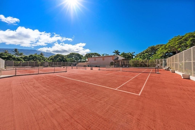 view of sport court featuring fence