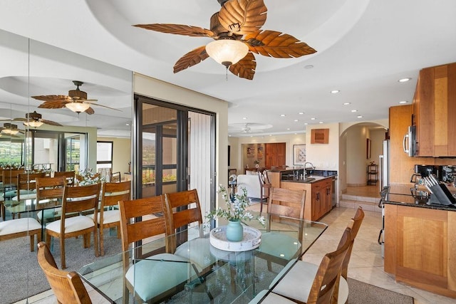 dining room with recessed lighting, a ceiling fan, arched walkways, and light tile patterned floors