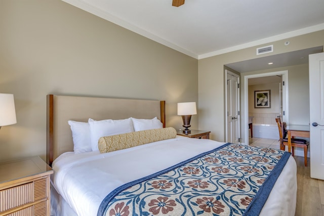 bedroom with ensuite bathroom, light hardwood / wood-style flooring, ceiling fan, and ornamental molding