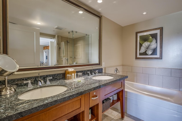 bathroom with tile patterned flooring, vanity, and independent shower and bath