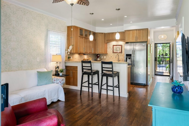 4435 Lower Honoapiilani Rd Unit 152, Lahaina, HI 96761 - kitchen featuring stainless steel fridge, wallpapered walls, light countertops, dark wood-style flooring, and a breakfast bar