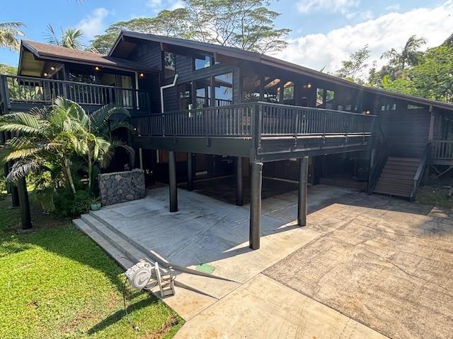 back of house featuring a carport and a wooden deck