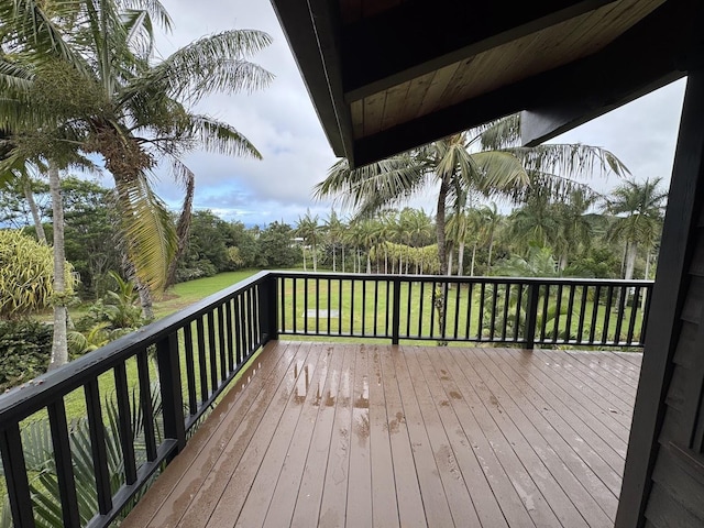 wooden terrace with a yard