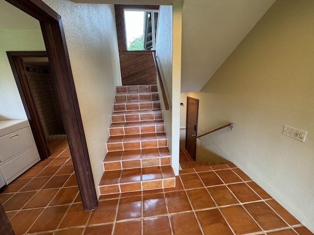 stairway with washer / dryer and tile patterned flooring