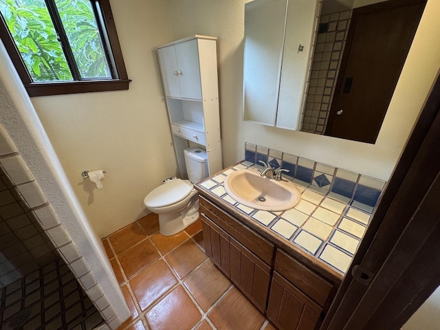 bathroom with vanity, tile patterned floors, and toilet