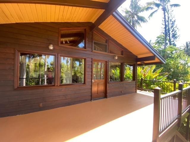 unfurnished sunroom featuring wood ceiling and lofted ceiling with beams