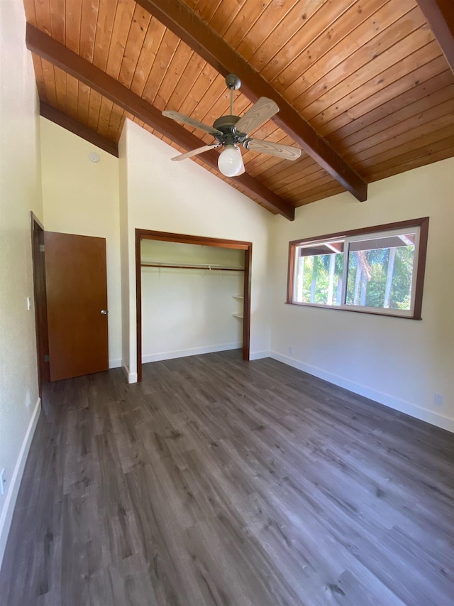 unfurnished bedroom with dark wood-type flooring, lofted ceiling with beams, wooden ceiling, a closet, and ceiling fan