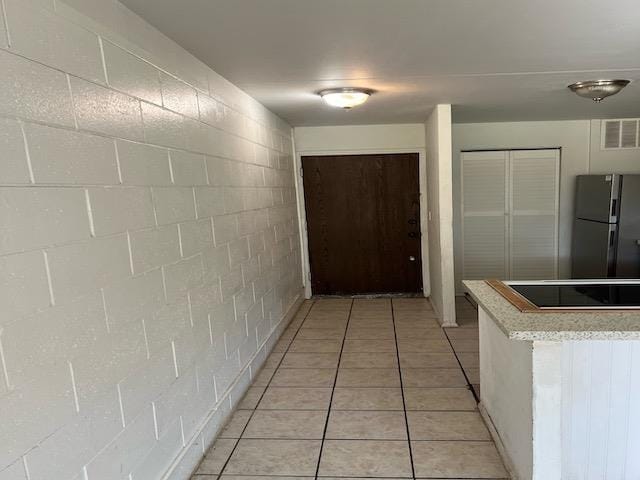 hall featuring light tile patterned flooring