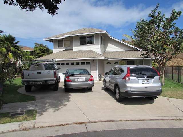 view of front of home featuring fence, concrete driveway, and roof with shingles