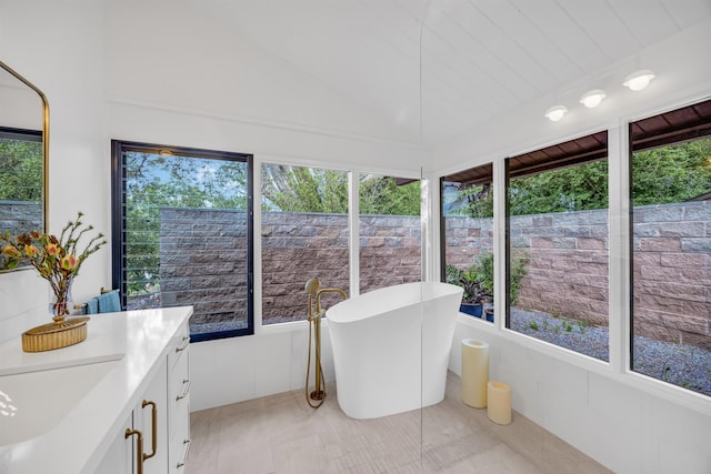 sunroom / solarium featuring tile patterned flooring and lofted ceiling