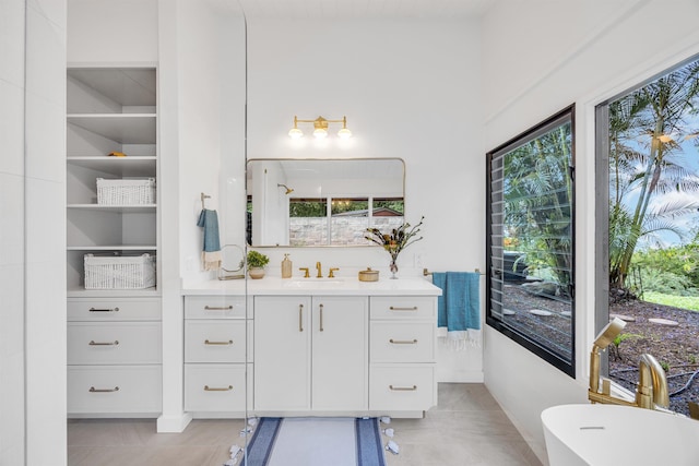 bathroom featuring built in shelves, vanity, and baseboards