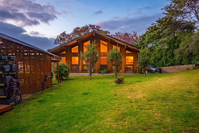rear view of property with a yard