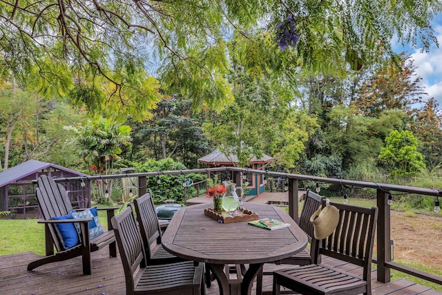 wooden deck featuring outdoor dining area