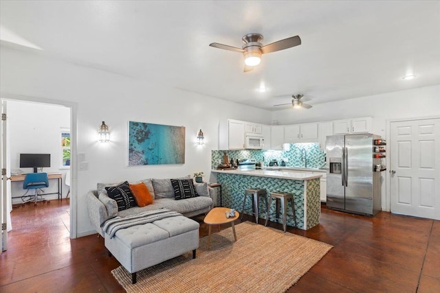 living room featuring ceiling fan and dark hardwood / wood-style floors