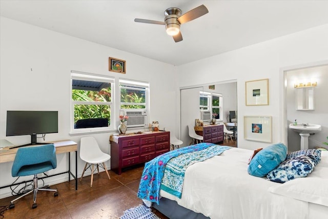 bedroom featuring ceiling fan, dark hardwood / wood-style floors, sink, and ensuite bath