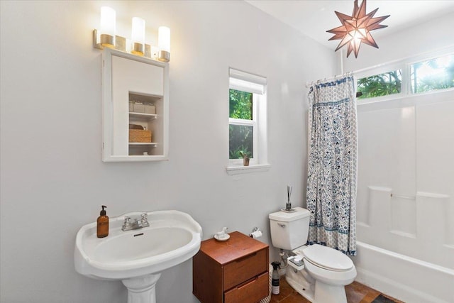 full bathroom featuring shower / bath combination with curtain, toilet, and sink