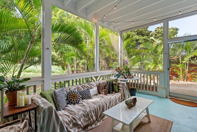 sunroom with beam ceiling and a wealth of natural light