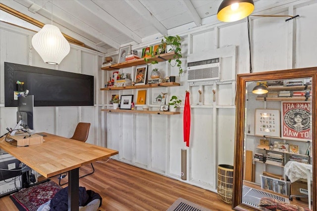 office space with lofted ceiling with beams, wood-type flooring, and a wall mounted AC