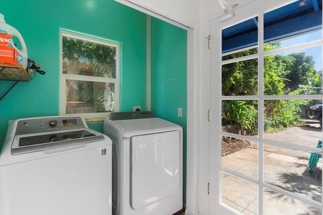 clothes washing area with washer and clothes dryer