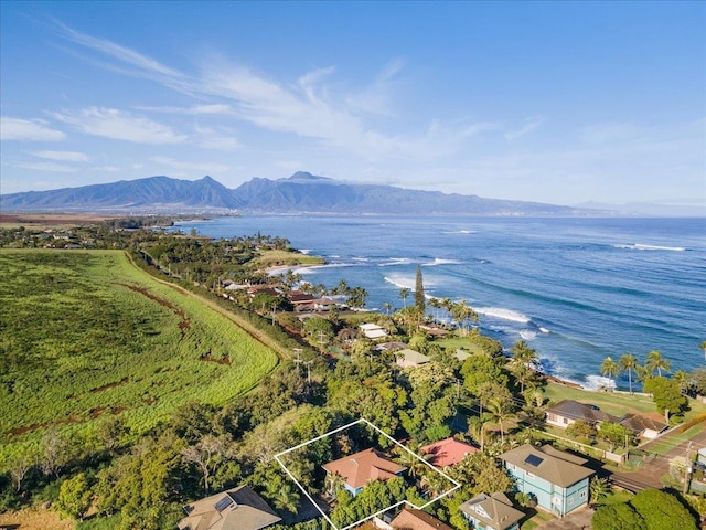 drone / aerial view featuring a water and mountain view