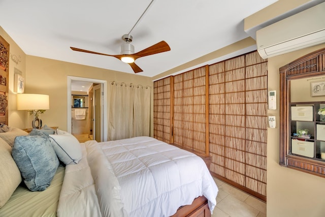 tiled bedroom with ceiling fan, ensuite bathroom, and a wall unit AC