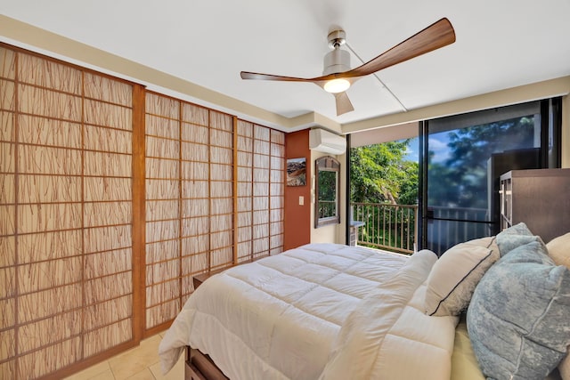 tiled bedroom with ceiling fan, a wall mounted AC, and access to outside