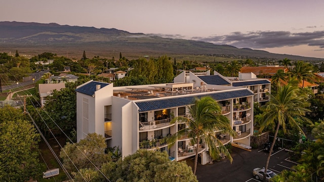 aerial view at dusk featuring a mountain view