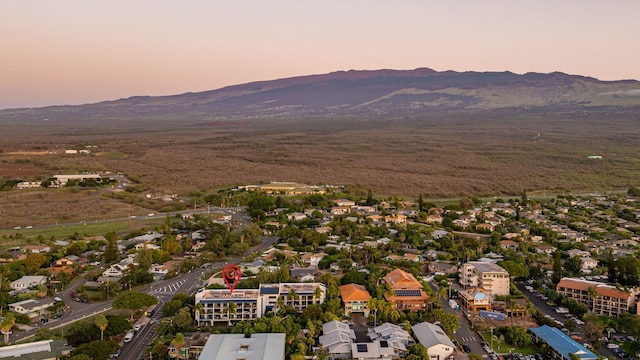 aerial view at dusk featuring a mountain view