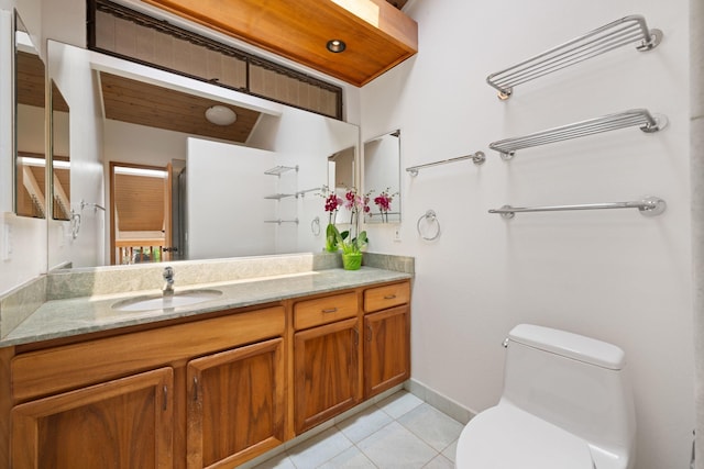 full bath featuring tile patterned floors, baseboards, toilet, and vanity