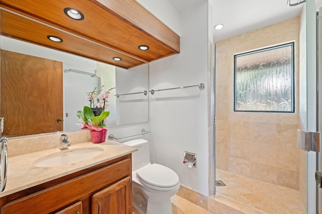 full bathroom with vanity, toilet, recessed lighting, and tiled shower