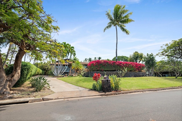 view of front of property with a front yard and fence