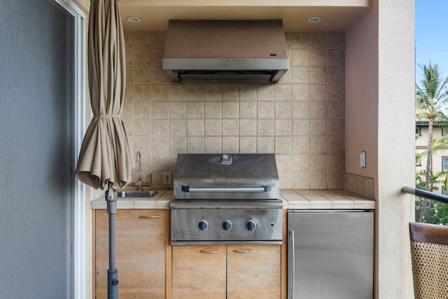 view of patio featuring a balcony, a grill, and sink