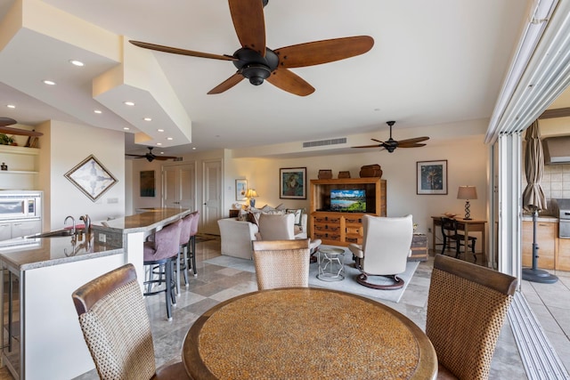 dining room with light tile patterned floors and sink