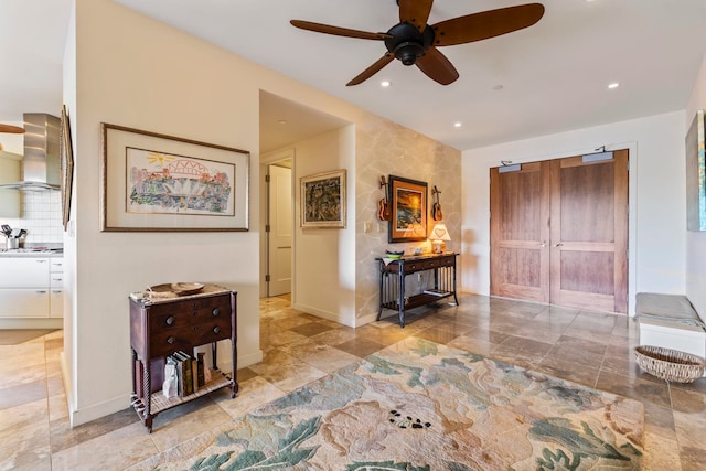 interior space with ceiling fan