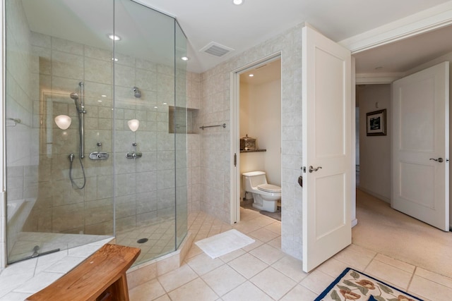 bathroom with toilet, an enclosed shower, and tile patterned floors